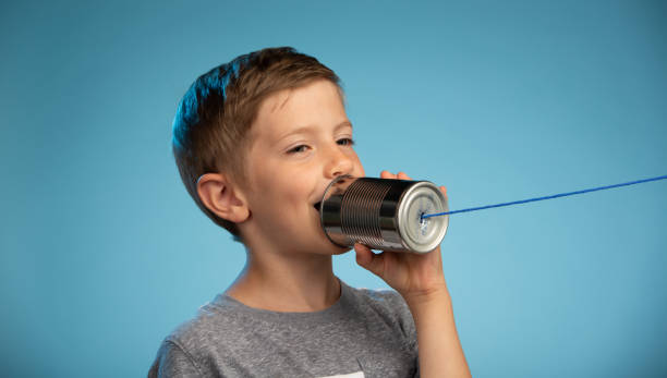 istock Adorable Little Boy Speaking Into Tin Can Phone 991733206