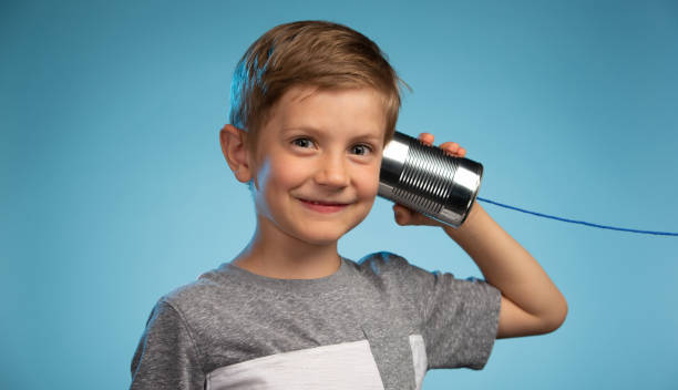 istock Adorable Little Boy with a Tin Can Phone 991733214