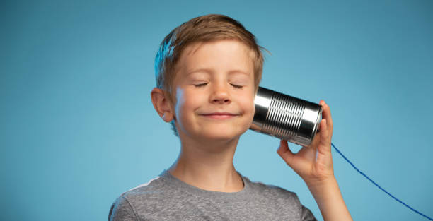 istock Adorable Little Boy with a Tin Can Phone 991733246