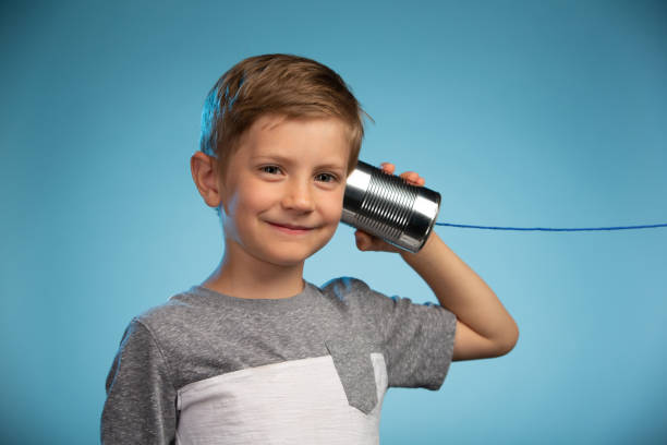 istock Adorable Little Boy with a Tin Can Phone 991733280