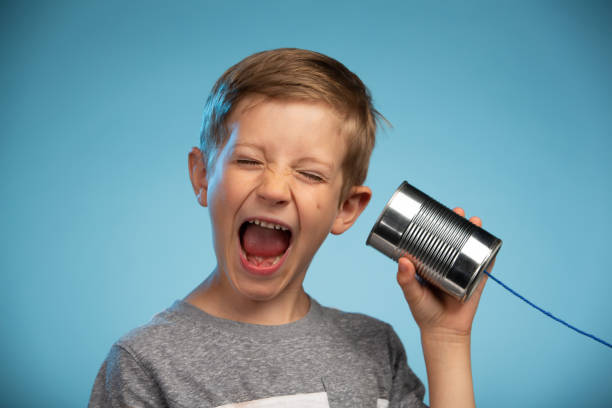 istock Adorable Little Boy with a Tin Can Phone 991733302