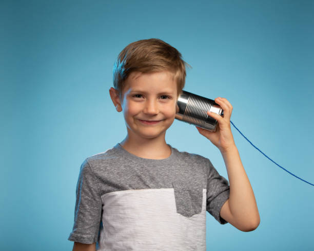 istock Adorable Little Boy with a Tin Can Phone 991733304