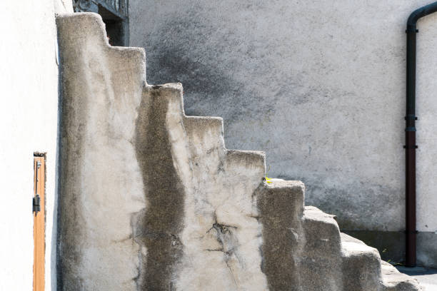 istock old stone stairs leading upwards with a plain wall and drainage pipe behind 991733344