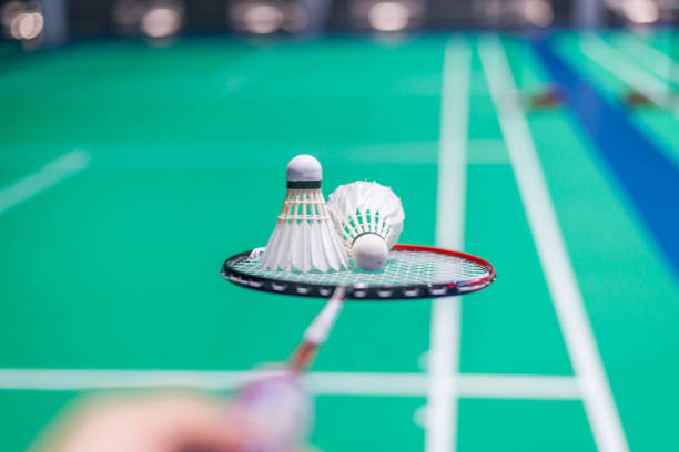 istock shuttercock on badminton racket with blurred background badminton player, indoor court. 991750302