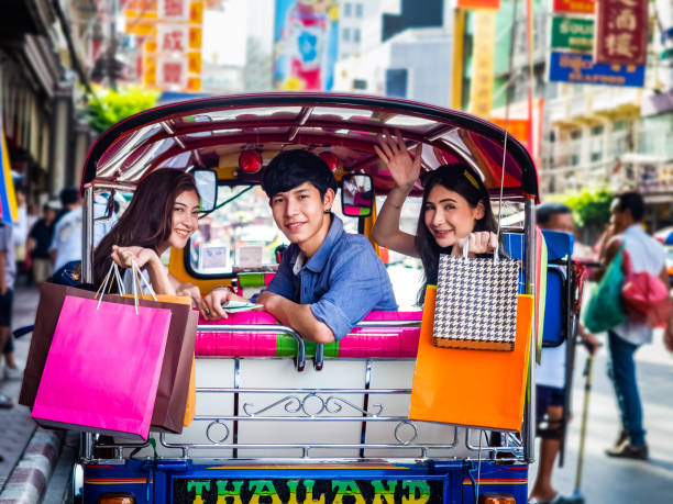 travel concept.group of happy friend are traveling.tourist holding shopping bag sitting in tuk tuk thai traditional taxi with blurring china town bangkok background. - asian ethnicity group of people tourist passenger zdjęcia i obrazy z banku zdjęć