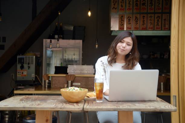 Woman working with a laptop at a bar