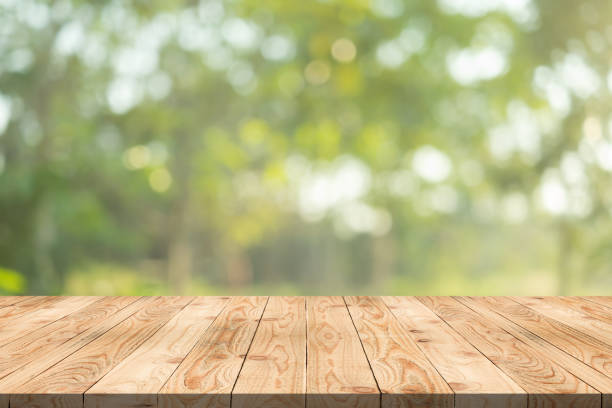 istock Empty wood table on blurred background copy space for montage your product or design,Blank brown board with abstract blurred background. 991798520
