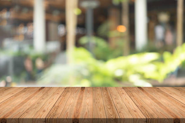 istock Empty wood table on blurred background copy space for montage your product or design,Blank brown board with abstract blurred background. 991798526