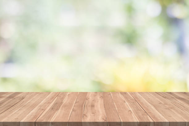 istock Empty wood table on blurred background copy space for montage your product or design,Blank brown board with abstract blurred background 991798528