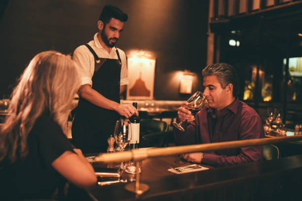 istock Mature man tasting wine before waiter serves at luxurious restaurant 991806448