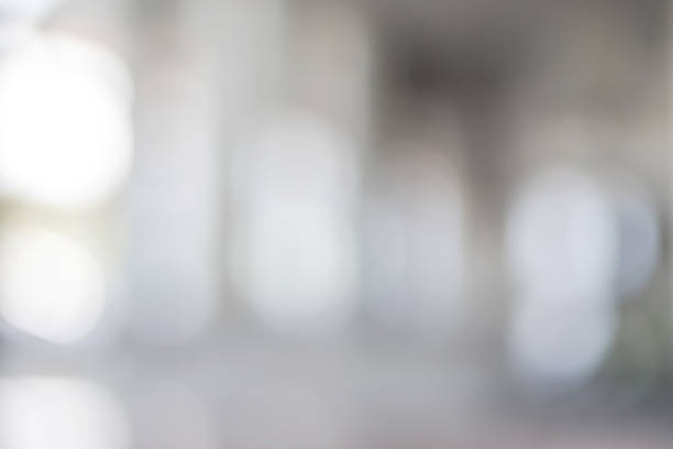 istock Blur office background interior view of empty lobby white room glass window wall with light bokeh 991811120