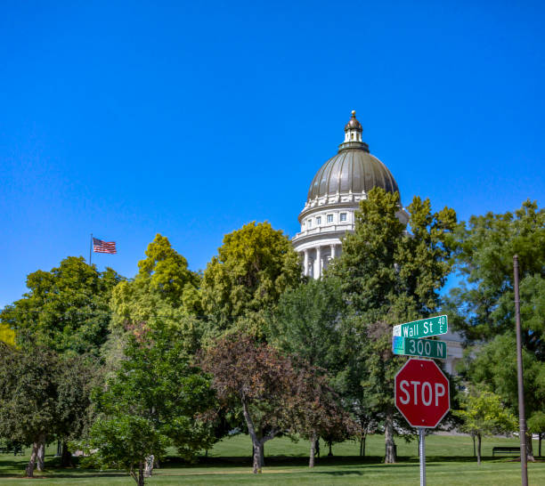 Utah State Capital building shown with foliage and a stop sign with