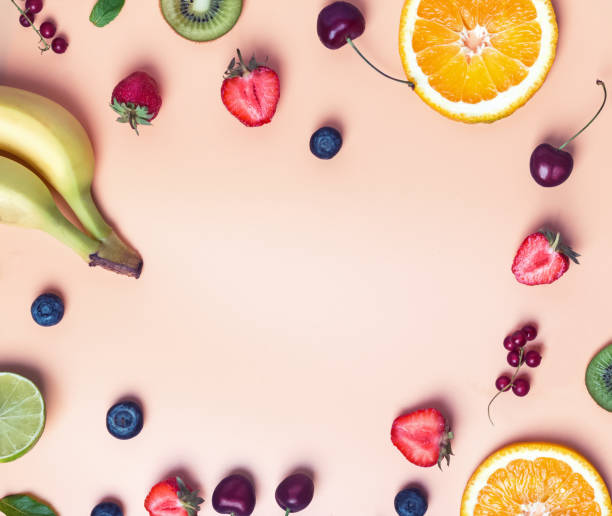 istock different fruits and berries on the pastel color background. 991815536