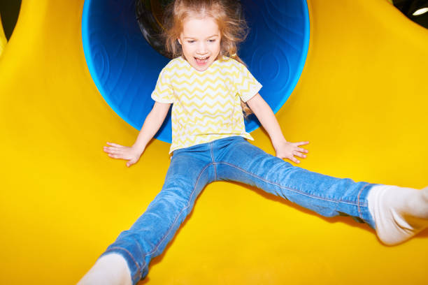 istock Happy Girl Going Down Slide 991816660