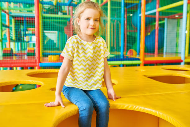 istock Cute Blond Girl Posing in Play Area 991816674