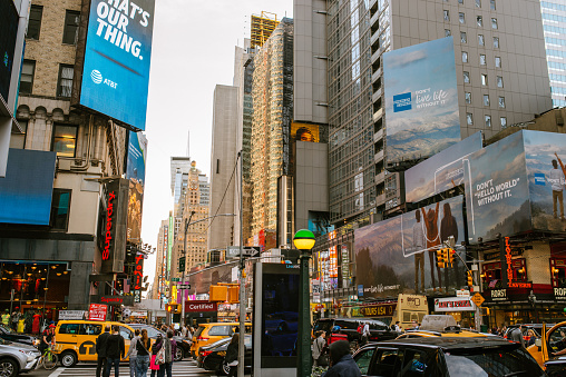 New York, USA - May 9, 2018: Crowded streets of New York City's 6th and 7th Avenue after working hours. While some parts of downtown districts are full of tourists exploring NYC, other  districts are busy with business people.