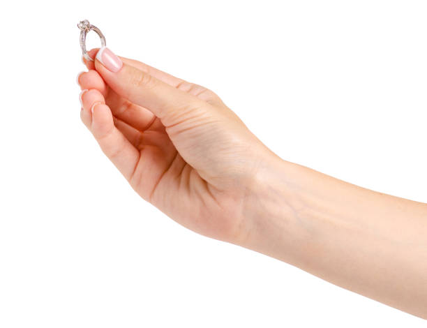 istock Female hand with a silver gold ring 991825090