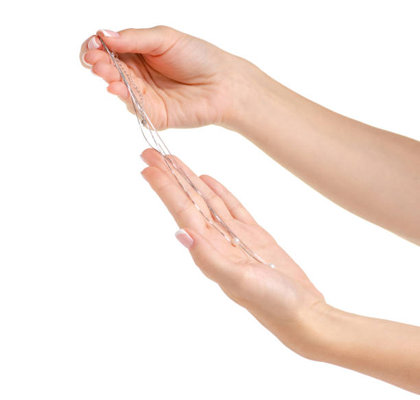 istock Chain of silver pearls in hand 991825260