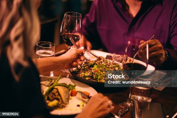 Couple Eating Quinoa Salad And Healthy Dinner At Restaurant Stock Photo - Download Image Now