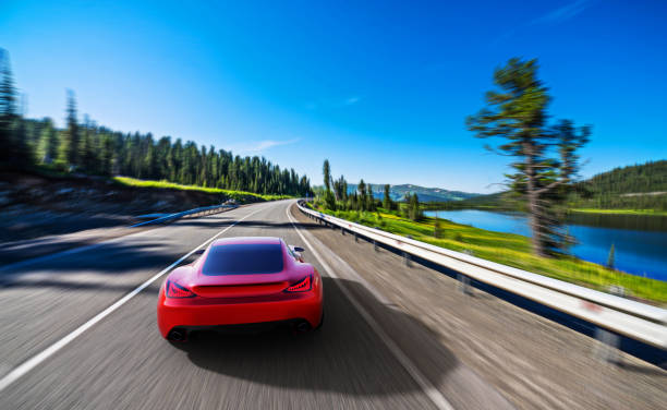 istock red car driving on a mountain road 991837744