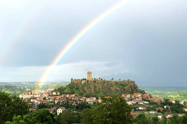 Polignac, Auvergne district in France . June 1, 2018. Landscape and Polignac castle with rainbow