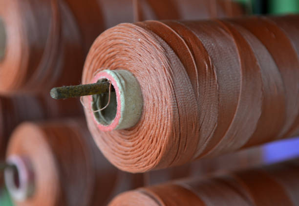Brown yarn cone mounted in a fabrics factory.
