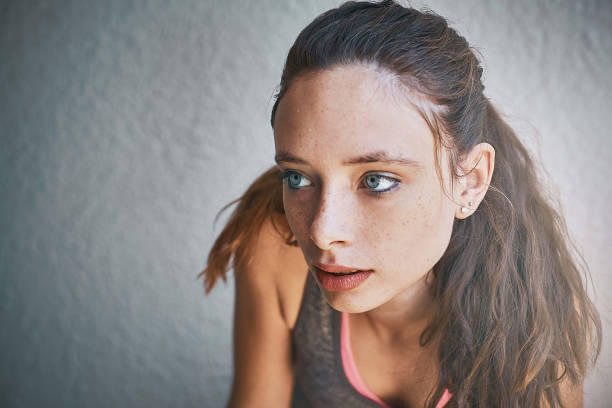 istock Headshot of beautiful young brunette against wall 991848006