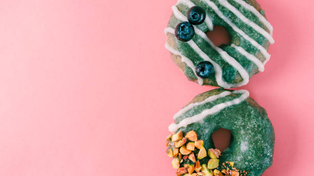istock Donut topped spirulina glaze on pink 991848410