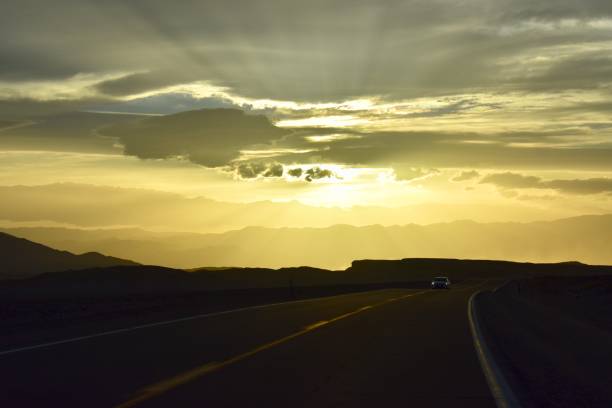 istock Car on the road through Death Valley Desert at Sunset 991851430