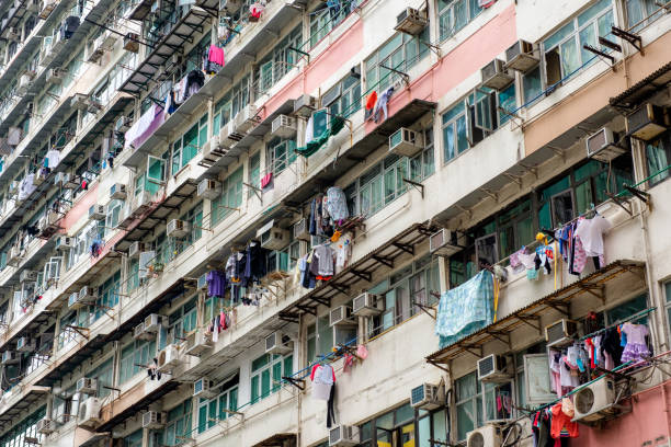 istock Ancient apartment building with aged windows with clothes line and air conditioner 991852418