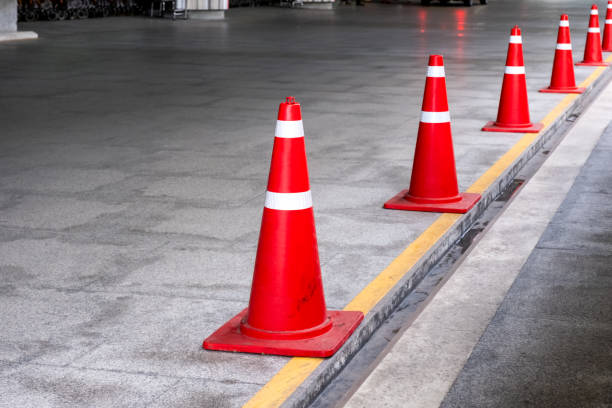istock Orange traffic cone or funnel standing a row at parking 991852714