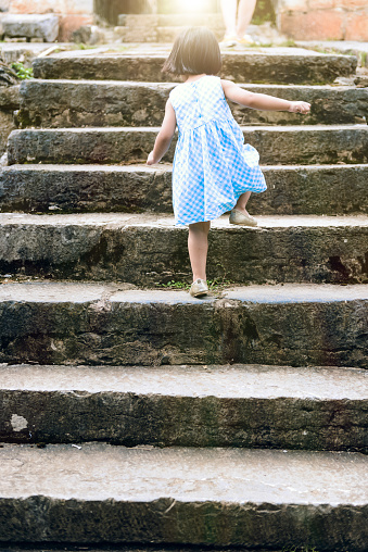 Little girl walking on the staircase