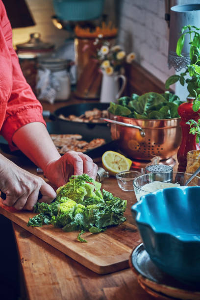 istock Preparing Cesar Salad with Chicken, Lettuce and Parmesan 991861442