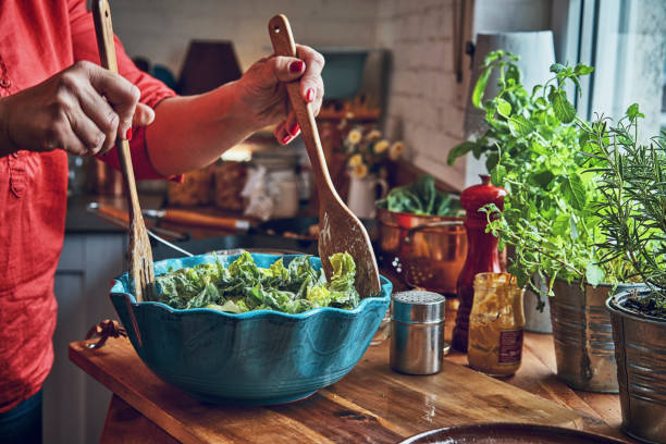 istock Preparing Cesar Salad with Chicken, Lettuce and Parmesan 991861446