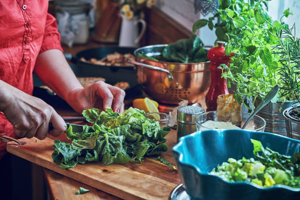 istock Preparing Cesar Salad with Chicken, Lettuce and Parmesan 991861498
