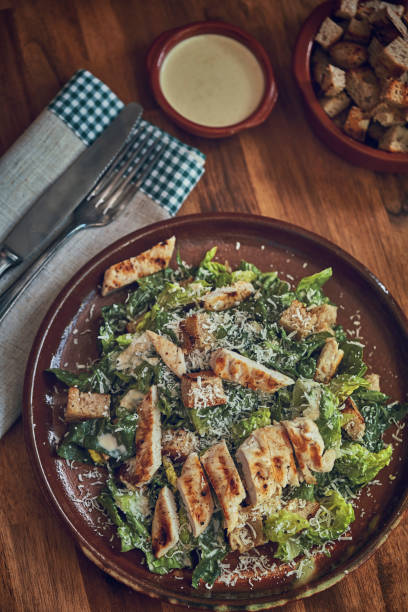 istock Homemade Cesar Salad with Chicken, Lettuce and Parmesan 991861848
