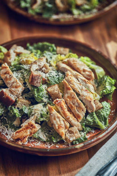istock Homemade Cesar Salad with Chicken, Lettuce and Parmesan 991861854