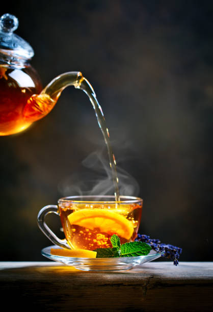 Process brewing tea,tea ceremony. Cup of freshly brewed black tea,warm soft light