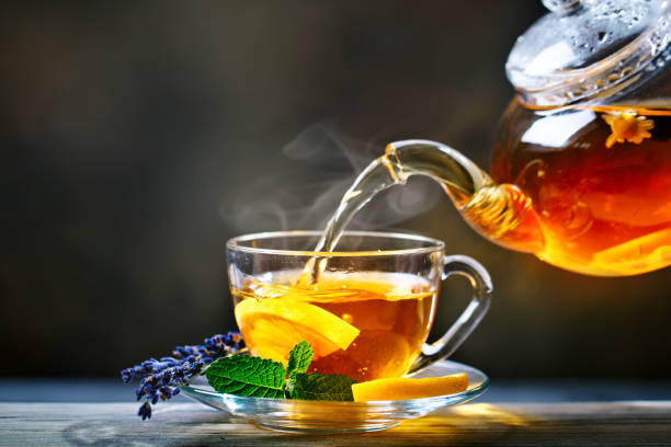 istock Process brewing tea,tea ceremony. Cup of freshly brewed black tea,warm soft light 991866154