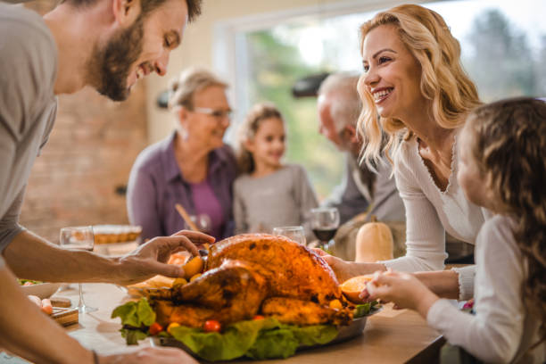 istock Happy family making final preparation on Thanksgiving day. 991881682