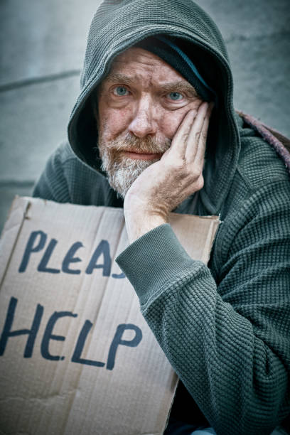 istock Social problem: destitute man begging in street 991890926