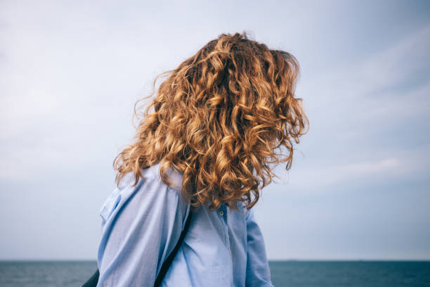istock Side view female's head on blue sea background 991892028