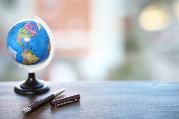 istock A pen on the desk and a small globe 991895932
