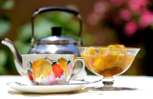 istock Cup of tea and a jur with the fig jam 991920700