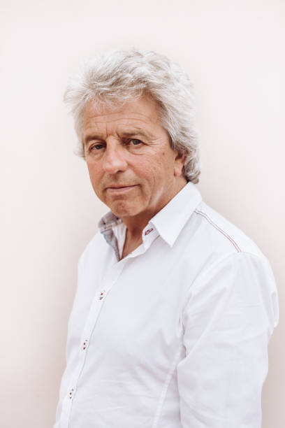 senior adult portrait on white wall