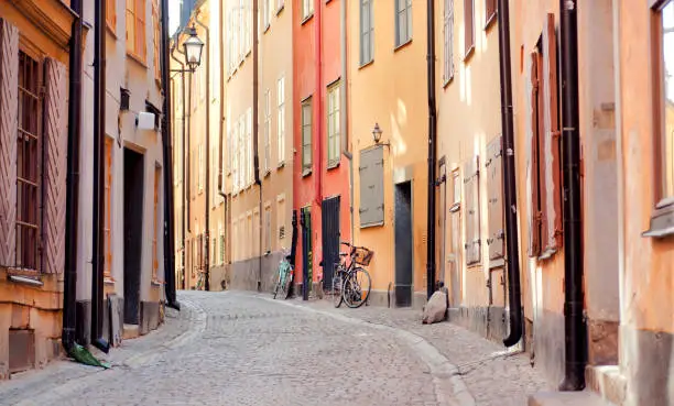 Photo of Historical houses and some bicycles in old city area. Gamla Stan of Stockholm with ancient street