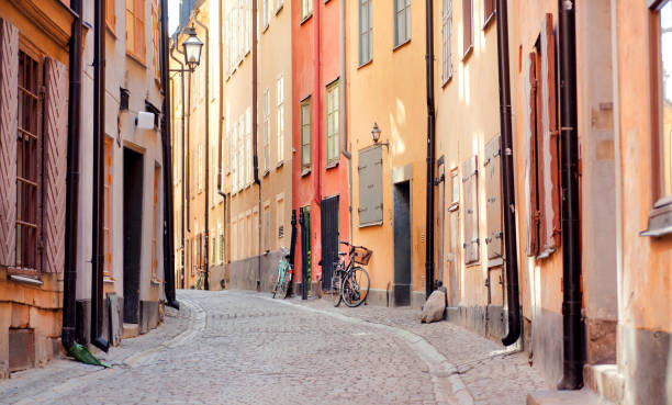 historical houses and some bicycles in old city area. gamla stan of stockholm with ancient street - sweden nobody building exterior architectural feature imagens e fotografias de stock