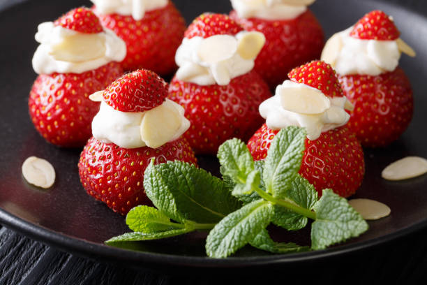 istock Beautiful food: strawberry with whipped cream, almonds and mint closeup. horizontal 991940492