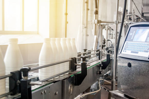 istock Conveyor belt with white milk bottles 991941056