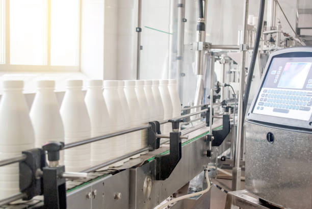 istock Conveyor belt with white milk bottles 991943462